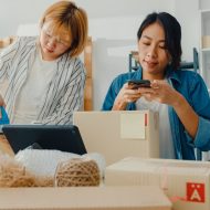 Young Asia businesswomen using mobile phone call receiving purchase order and check product on stock work at home office. Small business owner, online market delivery, lifestyle freelance concept.